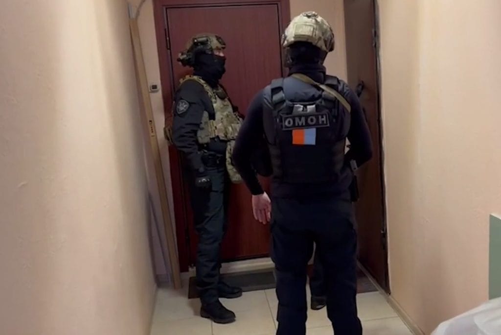 Law enforcement agents raid a house in a suspected money laundering probe.