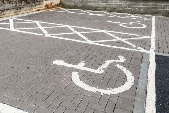 Wheelchair symbol painted on accessible parking space Wheelchair symbol painted on accessible parking space