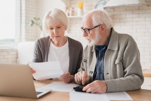 Serious caucasian old elderly senior couple grandparents family counting funds on calculator, doing paperwork, savings, paying domestic bills, mortgag Serious caucasian old elderly senior couple grandparents family counting funds on calculator, doing paperwork, savings, paying domestic bills, mortgag