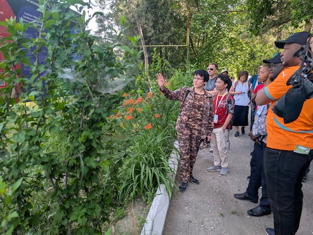 A park ranger guides delegates through one of Uzbekistan's protected landscapes, explaining ongoing conservation and restoration efforts. The visit highlighted how long-term biodiversity protection depends not only on strong environmental policies but also on innovative financing mechanisms capable of attracting private capital while safeguarding public conservation objectives. Credit: Kizito Makoye/IPS