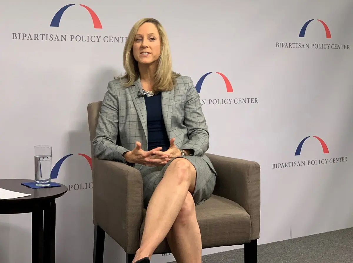 Kathy Kraninger sitting in a chair in front of a Bipartisan Policy Center backdrop