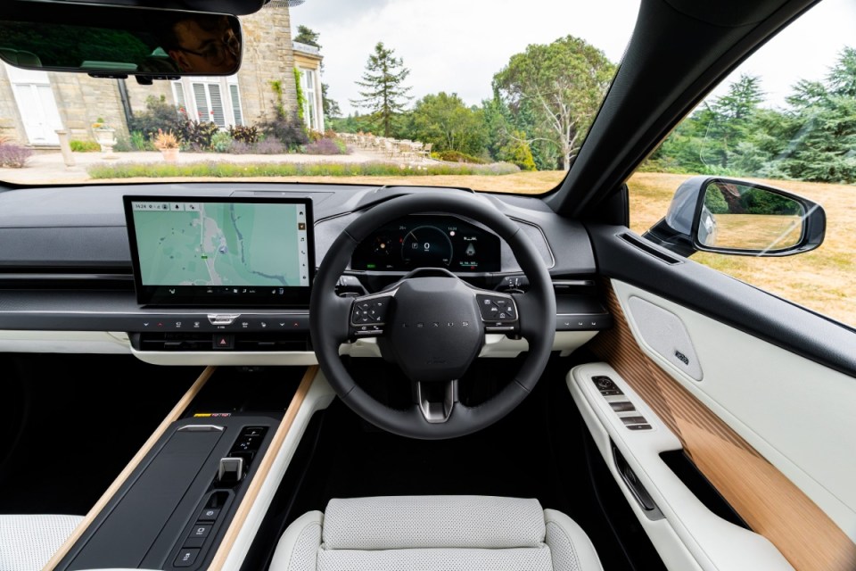 Lexus ES350e interior with touchscreen, steering wheel, white leather seats, and wooden trim