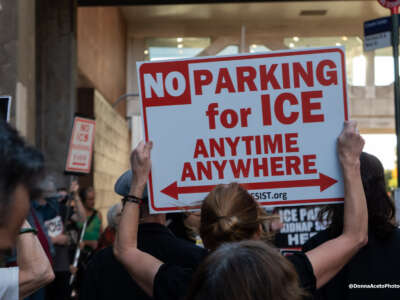 A protester holds a sign at a protest outside the Icon parking garage in Manhattan on September 14, 2026.