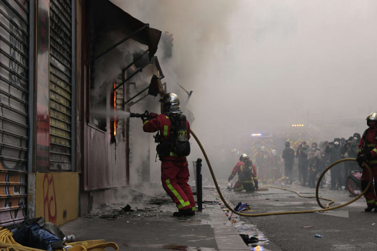 Firefighters put out a blaze set during student and cost-of-living protests in Paris, France, on October 17, 2026.