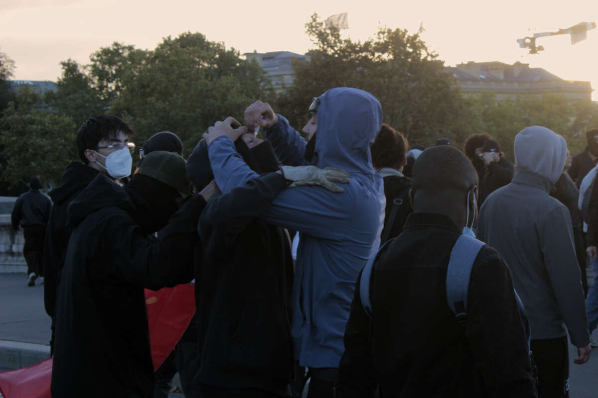 A protester helps another apply eye drops after having been tear-gassed during student and cost-of-living protests in Paris, France, on October 17, 2026.