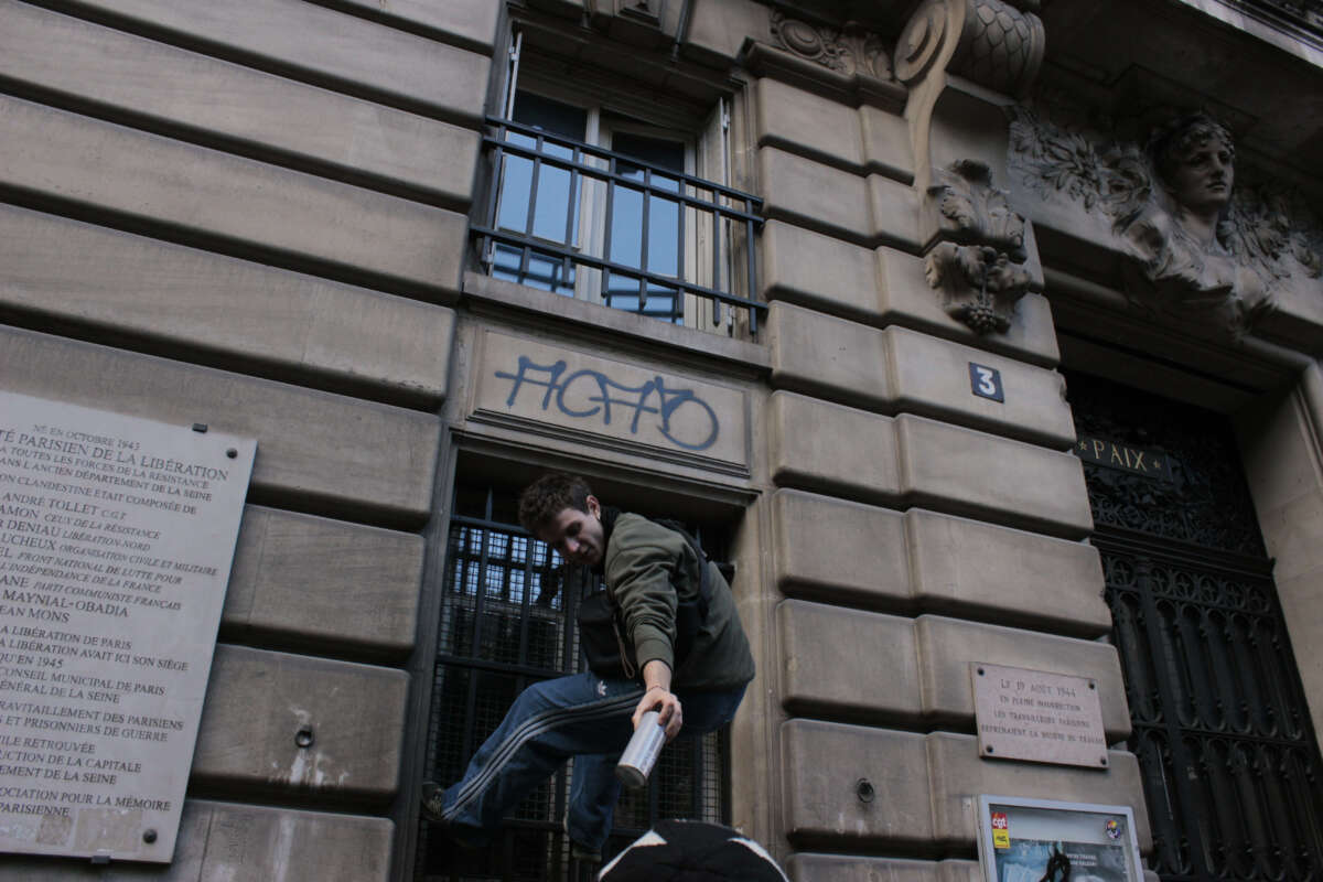 A protester tags a public building in Paris, France, on October 17, 2026.