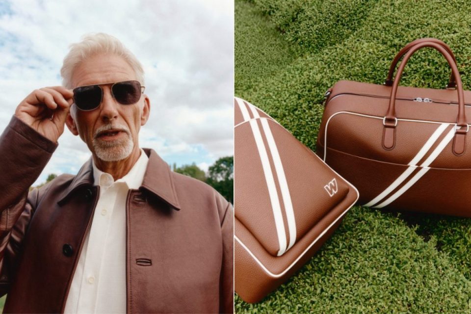 Older man in brown leather jacket adjusting sunglasses; brown leather bags with white stripes on grass
